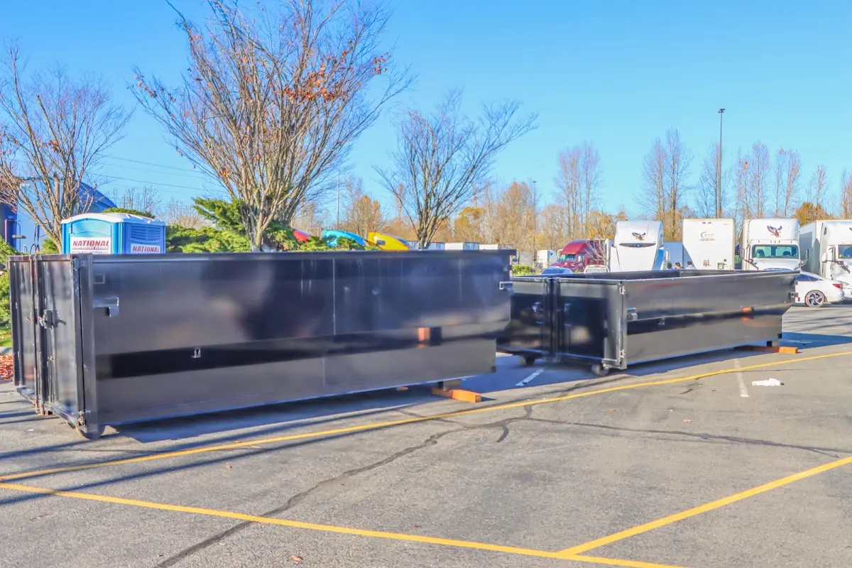Professional dumpster rental service with roll-off container on residential driveway in West Carson